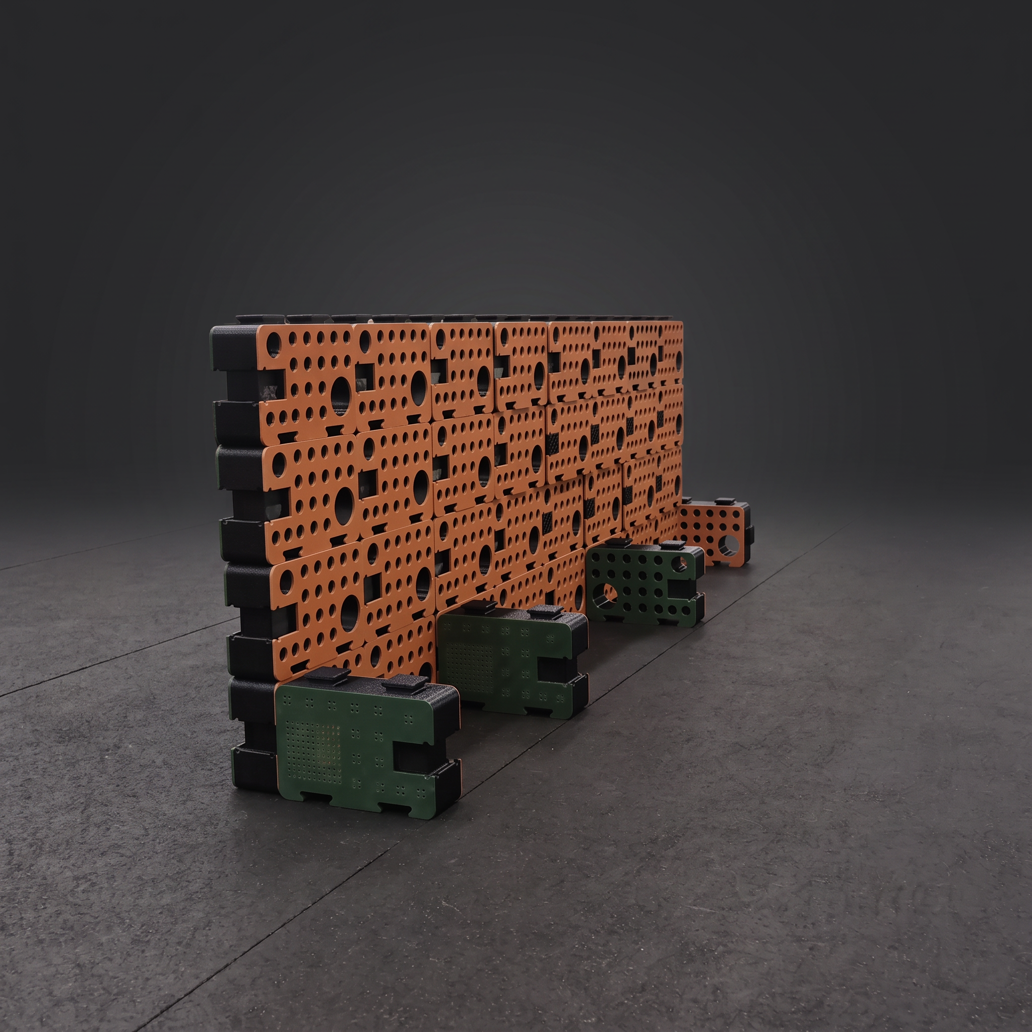 An orange D-Block wall with green blocks at the base forming search pockets, assembled in a training facility